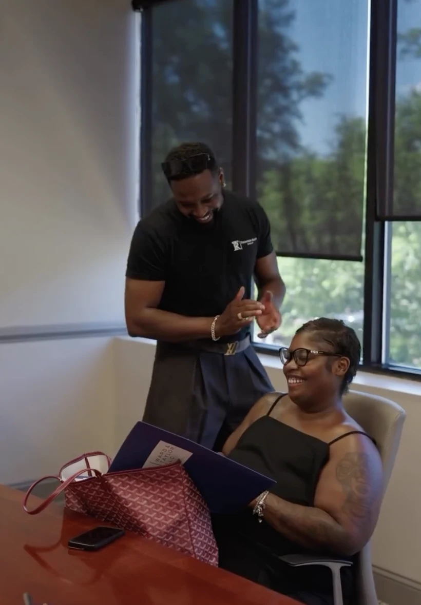 A Foraker Realty agent and client reviewing paperwork together