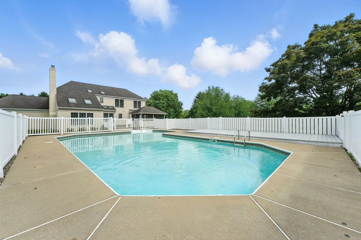 Backyard pool and fenced lawn